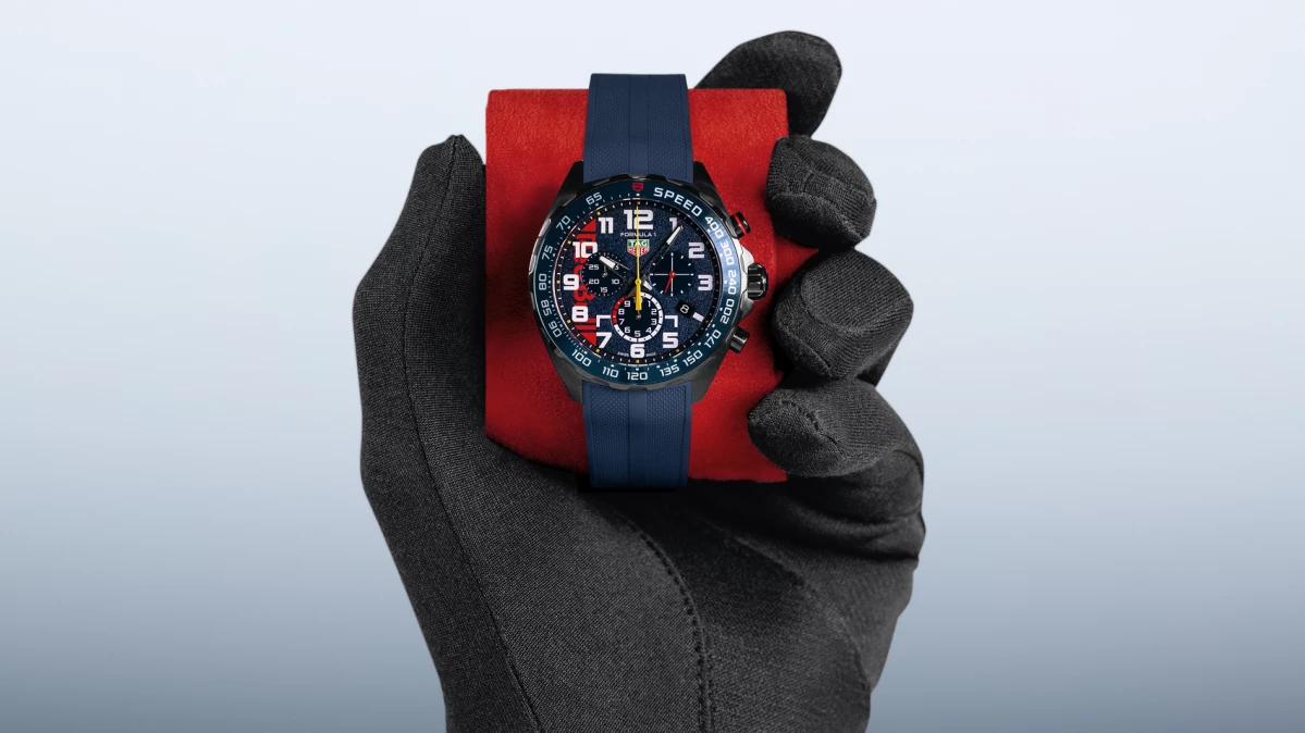 Formula 1 racing drivers gloved hand holding the new TAG Heuer Formula 1 Chronograph x Oracle Red Bull Racing Watch