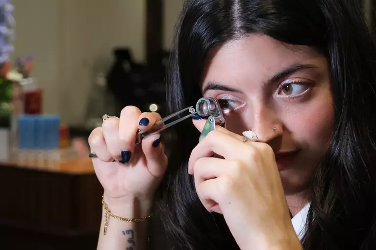 Alexandra from the Baker Brothers Sales team inspecting a loose diamond